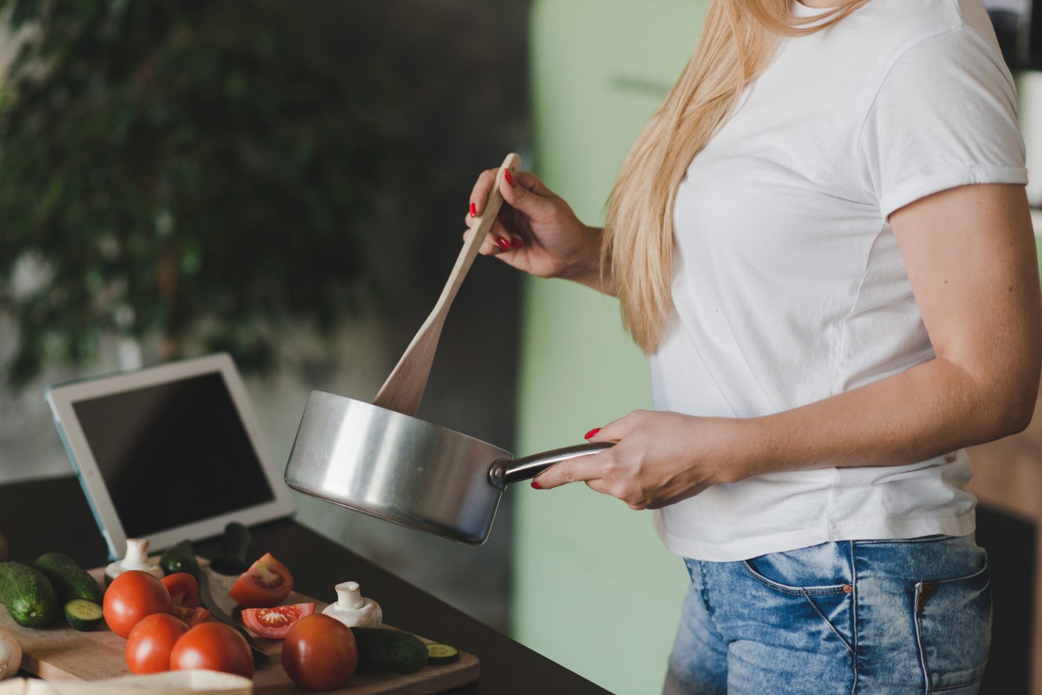 Realistic kitchen setup with essential cookware: cast iron skillet, non-stick pan, saucepans, deep oven dish, and large pot on a wooden countertop.