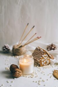 Realistic gingerbread house decorated with candies and icing on a holiday table.